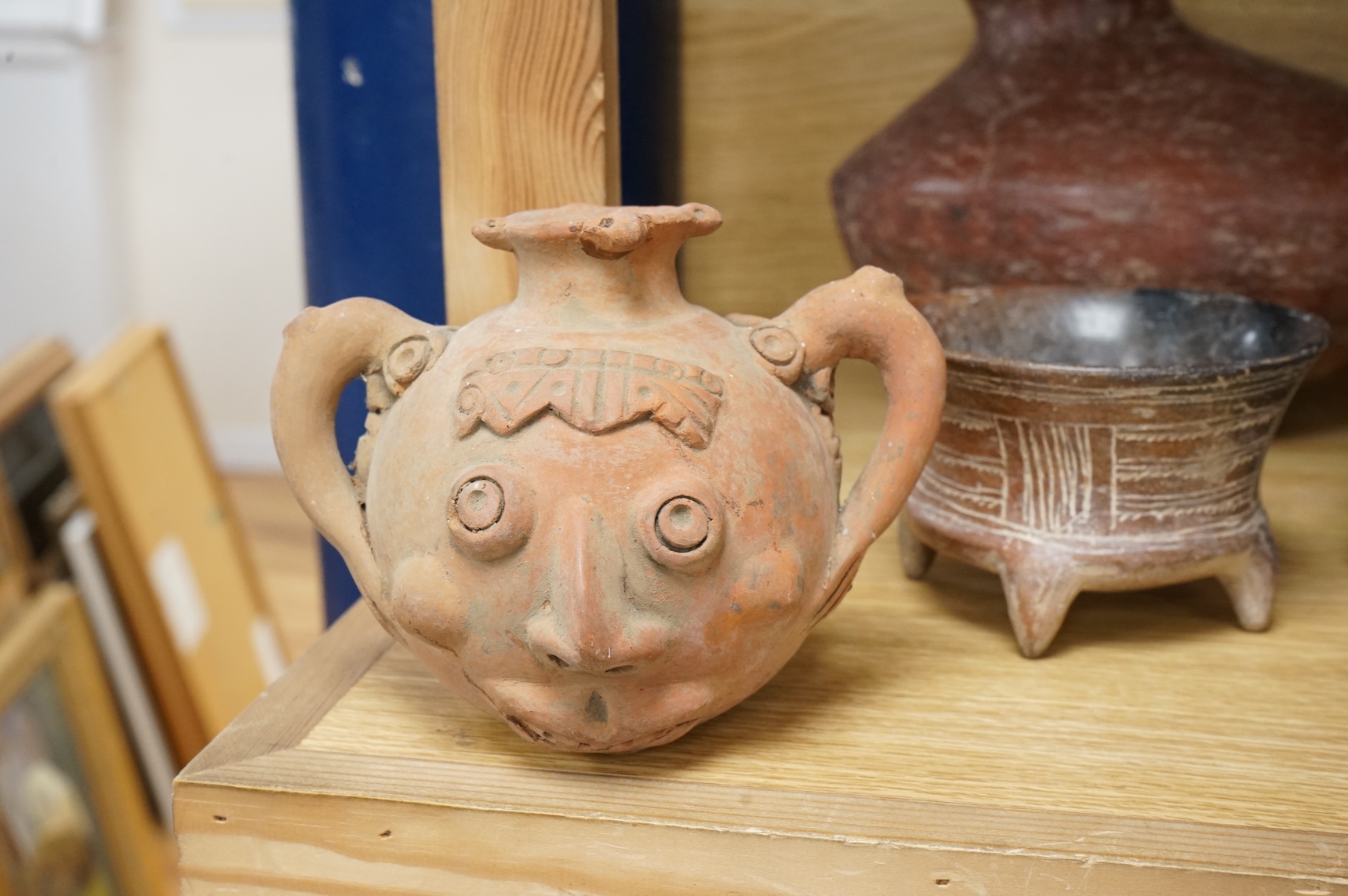 A collection of various South American vessels some in the form of grotesque heads, largest 24cm wide